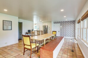 A spacious kitchen with a large dining table, chairs, and a built-in bench. - Riverfront Gem w/ Fire Pit in Eden (Eden)