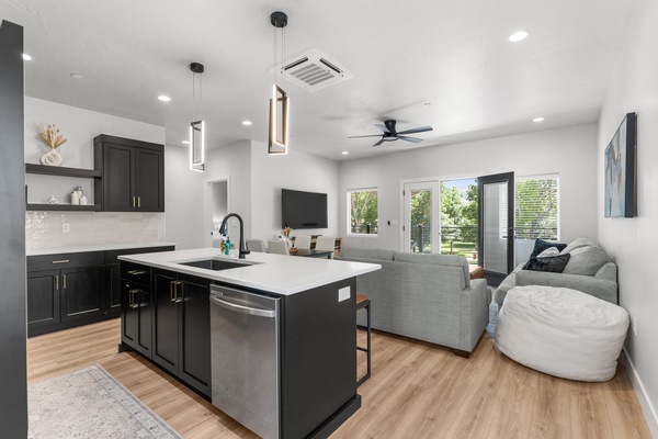 Open concept kitchen and living space with incredible views of Heritage Park from private balcony!