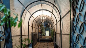 A corridor with a tiled floor, a metal railing, and a chandelier. - lotus Altahrir hotel (Cairo)