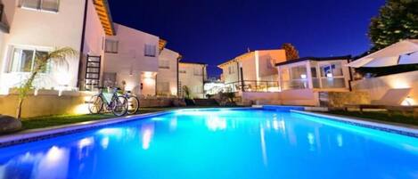 Residents can enjoy a pool and scenic views from their balcony.