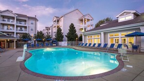 A swimming pool with lounge chairs and umbrellas, surrounded by multi-story buildings with balconies. - Experience the Best of Music City at Wyndham Nashville- 2 Bd. Lockoff (Nashville)