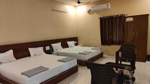 A hotel room with two beds, a desk, and a chair. - LIMRA FARM HOUSE  (Anaimalai)