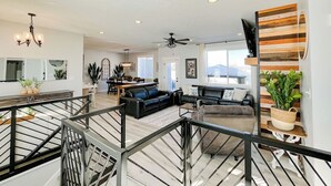 A spacious living area with a staircase, a dining area, and a kitchen. - Cozy 6 bedroom home minutes from Rigby Lake (Rigby)