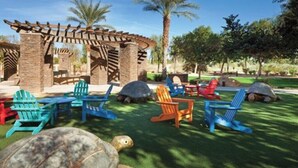 A patio area with outdoor seating and a pergola structure.