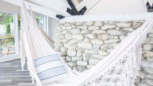 A hammock suspended between white beams, a stone wall, and a wooden floor. - Lakehouse - Sleeps up to 20 w/ free boat slip.
WINTER REMODEL - PICS COMING SOON (Noblesville)