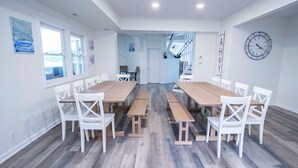 A spacious dining area with wooden tables and white chairs, large windows, and a clock on the wall. - Lakehouse - Sleeps up to 20 w/ free boat slip.
WINTER REMODEL - PICS COMING SOON (Noblesville)