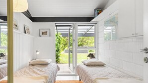 A bedroom with two beds, a large window, and a view of greenery outside. - Awesome home in Sydals with WiFi (Sydals)