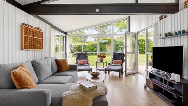 A modern living room with a grey sofa, two armchairs, a coffee table, and a TV stand. - Awesome home in Sydals with WiFi (Sydals)
