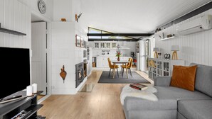 A modern living room with a grey sofa, a flat-screen TV, and a fireplace. - Awesome home in Sydals with WiFi (Sydals)