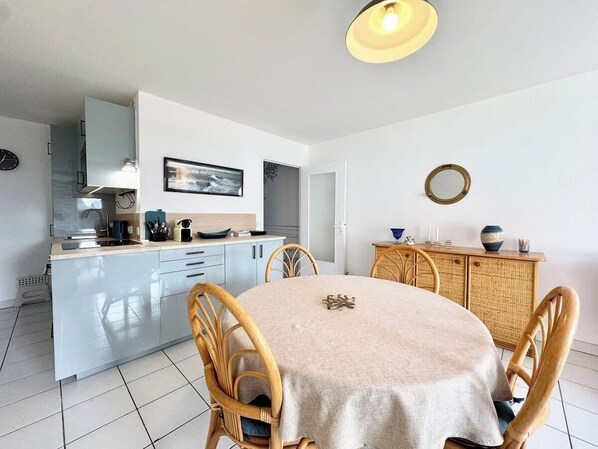 A modern kitchen with a dining area.