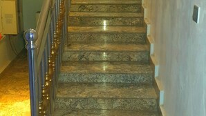 A marble staircase with a metal handrail, leading to an upper floor. - Bly & Schol Apartments (Abuja)