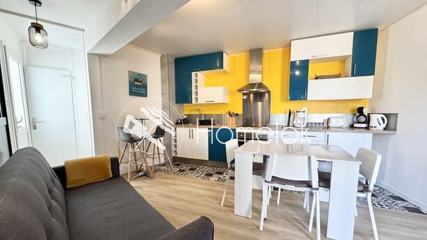A modern apartment with a living area, dining space, and kitchen.