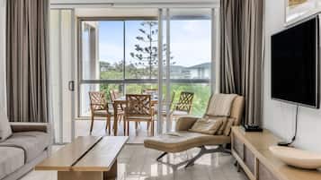 Deluxe Apartment, 3 Bedrooms, Garden View | Living area | Flat-screen TV