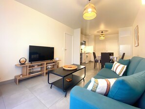 Relax in this stylish living space with a flat-screen TV, comfortable sofa, and functional coffee table.