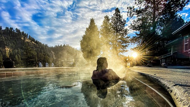 A person in a clear pool with a view of trees and a building in the background. - Private Hot Spring, Perfect for Couples, No Shared Spaces, 1 Hour North of Boise (Garden Valley)