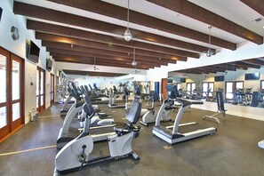 A gym with treadmills, exercise bikes, and weight machines.