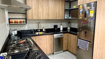 Fridge, coffee/tea maker, cookware/dishes/utensils