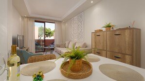 A modern living room with a sofa, dining table, and a cabinet.