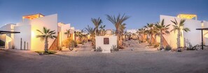 Welcome to our hotel, featuring a symmetrical entrance with a kiosk and beautifully landscaped grounds.