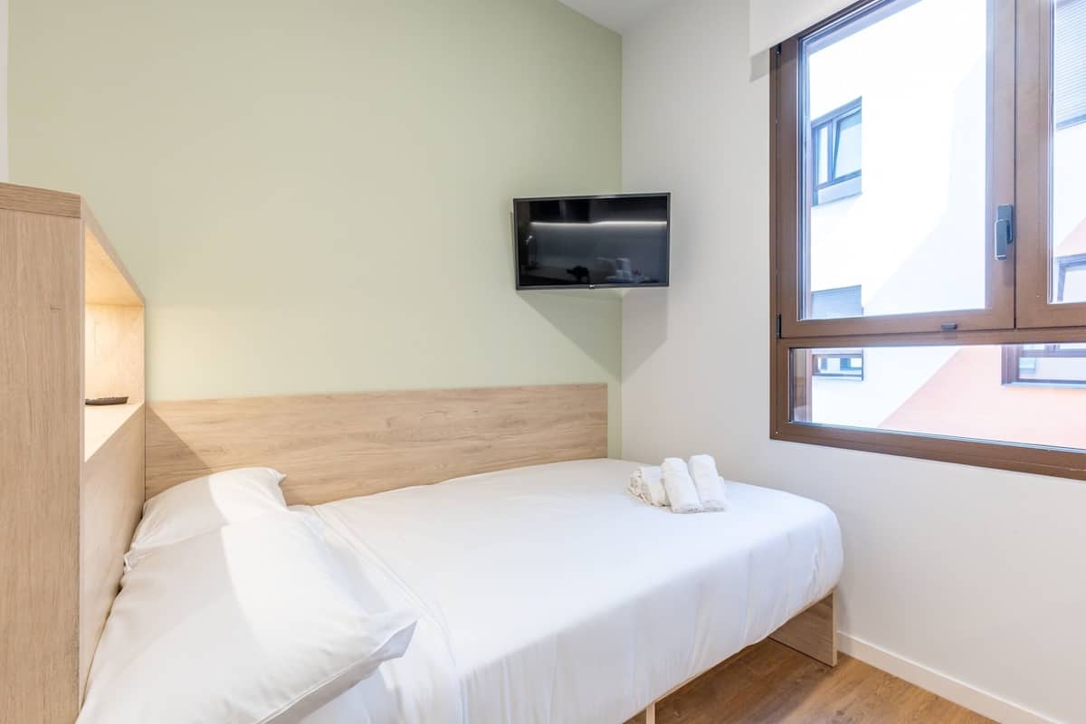 1 bedroom, desk, laptop workspace, bed sheets