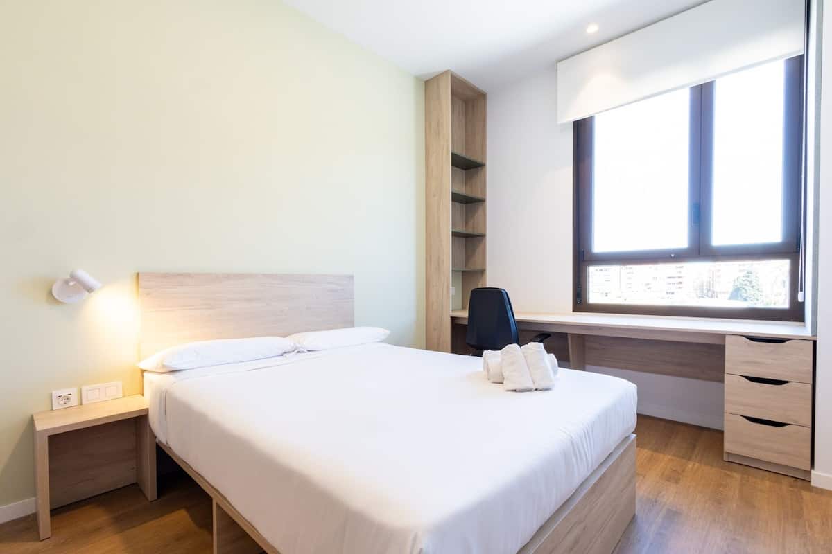 1 bedroom, desk, laptop workspace, bed sheets