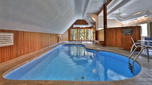 An indoor swimming pool with wooden walls, a ceiling with visible ductwork, and a sign indicating no glass permitted. - The Powder Pad Studio - Perfect for Two - On Shuttle Route w/ Amenities A4A (Killington)
