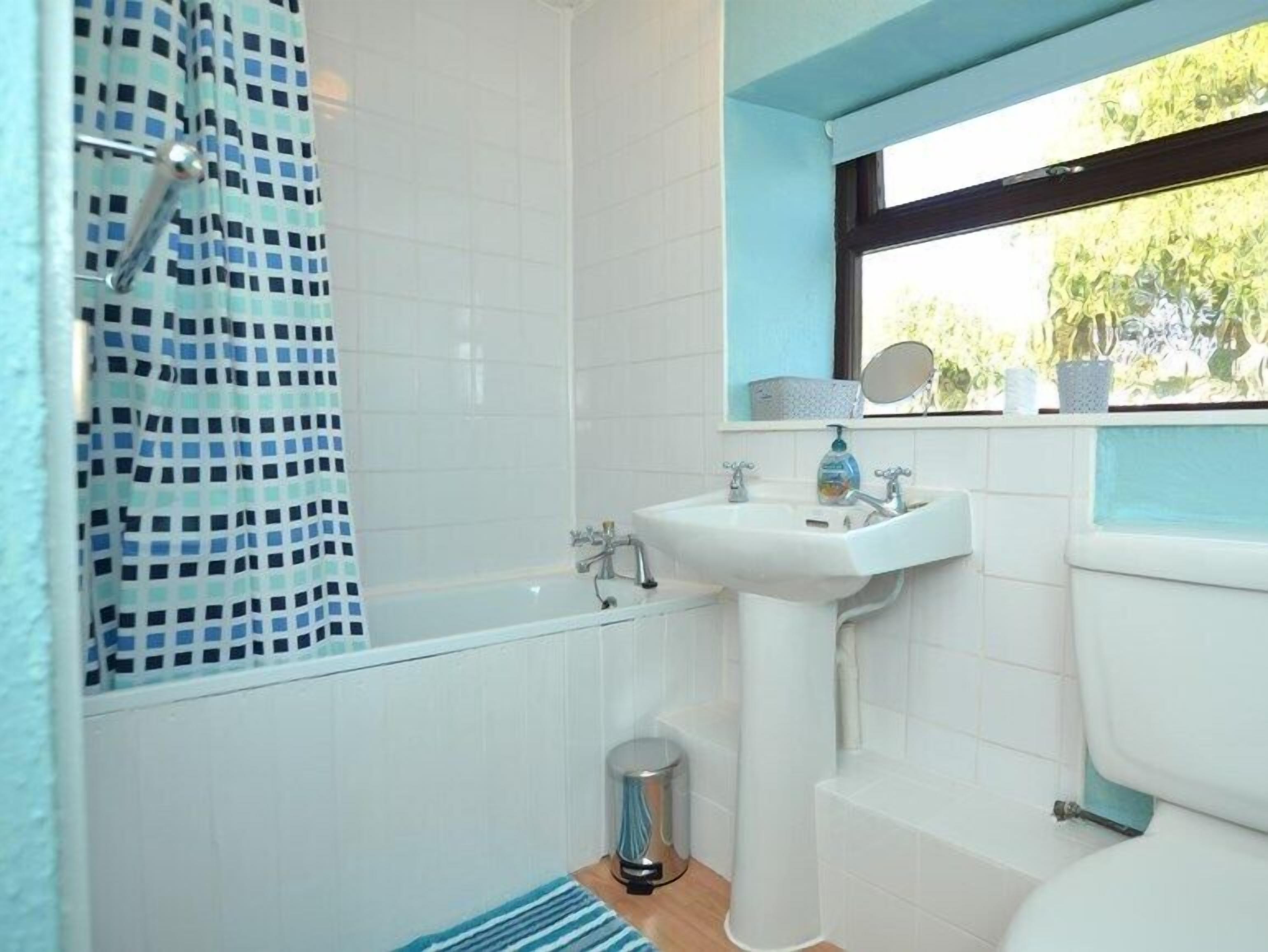 A bathroom with a bathtub, a sink, and a toilet.