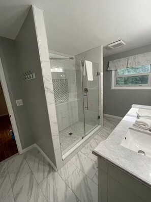 Shower, hair dryer, towels, toilet paper