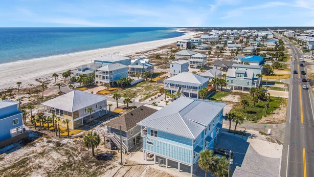 A coastal residential area with beachfront properties, a main road, and a beach. - New Listing! Luxury Beachside Townhouse GR8 Views! (Mexico Beach)