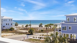 A beachfront property with a view of the ocean, featuring a white building with a balcony and a separate structure with a flat roof. - New Listing! Luxury Beachside Townhouse GR8 Views! (Mexico Beach)