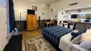 A compact room with a bed, a desk, a kitchenette, and a wardrobe. - Salmon River Inn (Salmon)