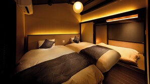 A hotel room with two beds, a ceiling fan, and a wall-mounted air conditioner. - Kanade Kiyomizu Gojo (Kyoto)