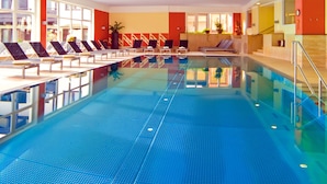 A swimming pool with lounge chairs and a tiled floor. - Apartment Edith by Interhome (Imst)