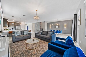 Relax in this stylish living space with a sofa set, dining area, and modern kitchen.