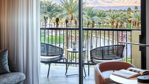 A balcony with two wicker chairs, a small table, and a sofa. - Marriott Desert Spring Villas- available march 2-9 only (palm desert)