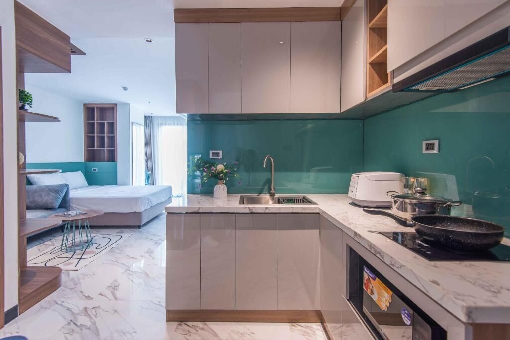 A compact kitchen with a built-in stove, a sink, and a countertop.