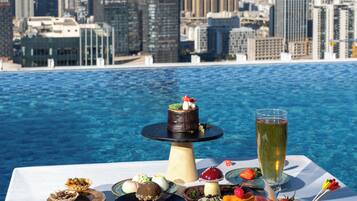 Outdoor pool, open 10:00 AM to 9:30 PM, pool umbrellas