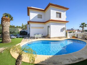 Relax by the pool surrounded by palm trees and lounge in comfort.