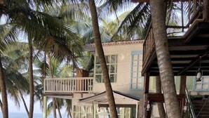 A beachfront property with a multi-level structure, including balconies and a staircase leading to the upper levels. - Belantara Beach Front Resort (Vengurla)