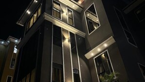 A modern building with multiple windows and a balcony. - Ace Homes Kampala (Kampala)