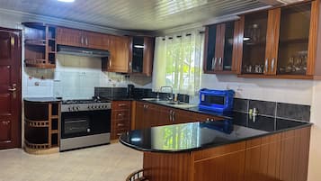 Family Bungalow, Garden View | Private kitchen | Fridge, microwave, cookware/dishes/utensils, dining tables