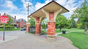 A brick pavilion with a stop sign and a fire hydrant nearby.