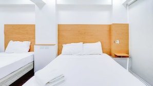A hotel room with two beds, wooden headboards, white bedding, and a small wooden nightstand. - Townhouse Oak BRBlock Boutique and Residences, Kalayaan Avenue, Near Ayala Mall, Poblacion, Makati, Manila (Makati)