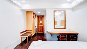 A bedroom with a bed, a desk, a chair, a mirror, and a wardrobe. - Townhouse Oak BRBlock Boutique and Residences, Kalayaan Avenue, Near Ayala Mall, Poblacion, Makati, Manila (Makati)