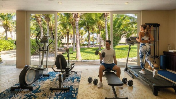 A gym with exercise equipment, a treadmill, and a bench. - Amazing Nicole 1 Ocean Views (Troncones)