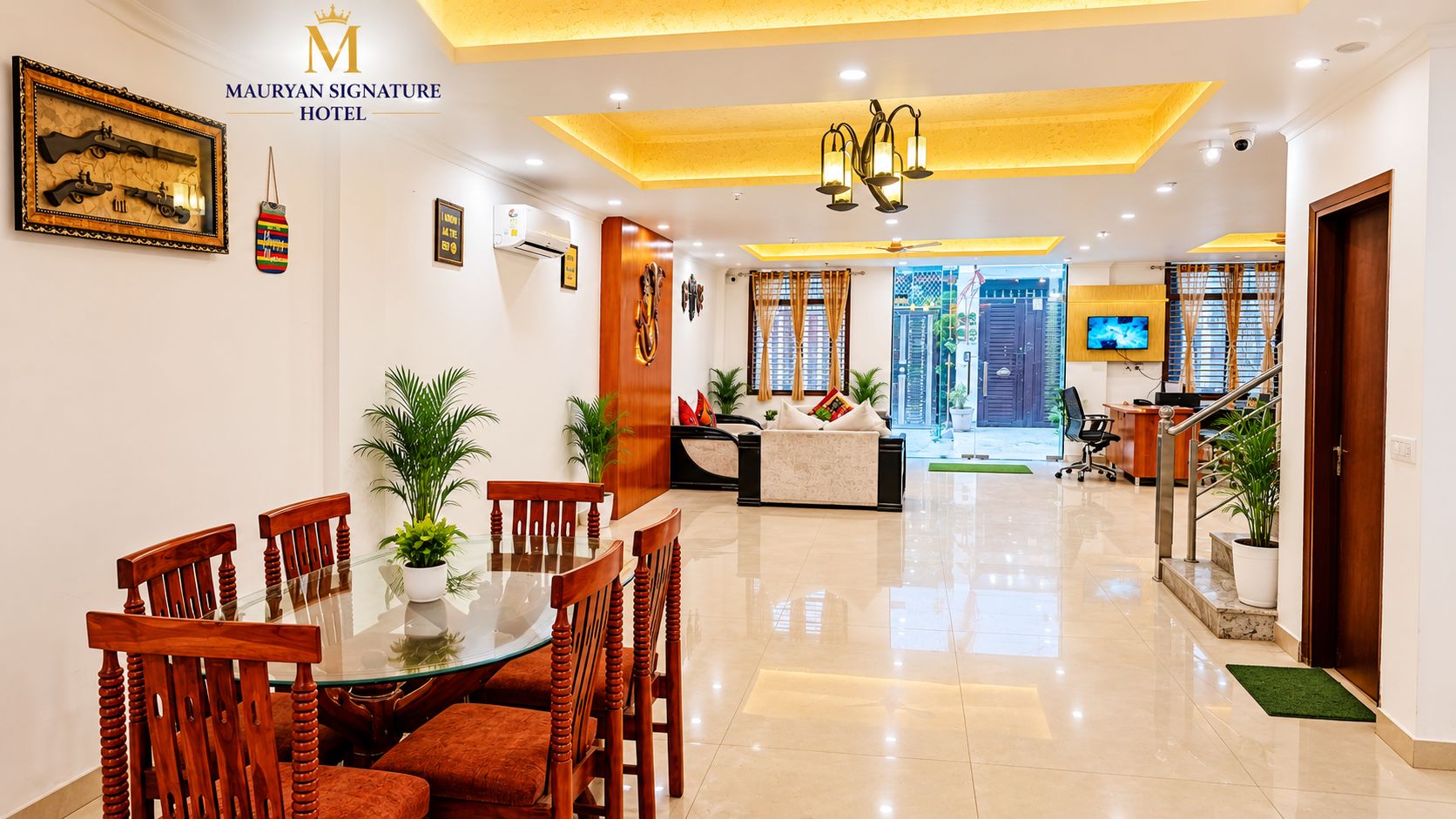 A hotel lobby with a dining area, a reception desk, and a staircase leading to other floors.