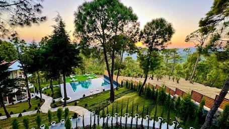 Outdoor pool. KUMAON ECO RESORTS