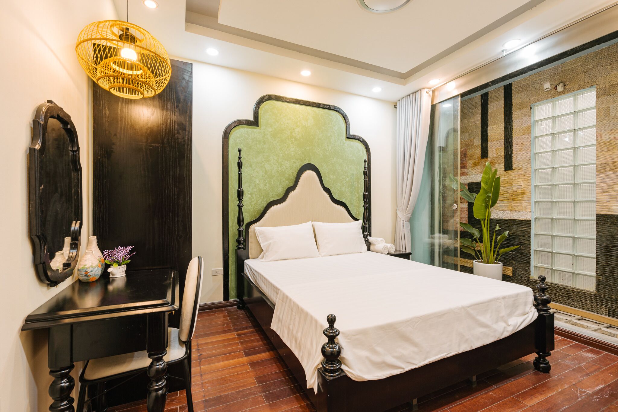 A neatly arranged bedroom with a bed, a desk, and a chair.