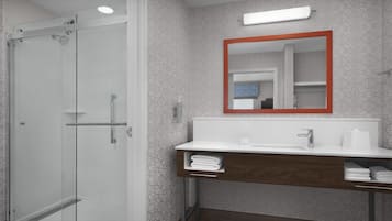 Casa de banho moderna com cabine de duche em vidro, toucador branco com base de madeira e espelho com moldura vermelha.