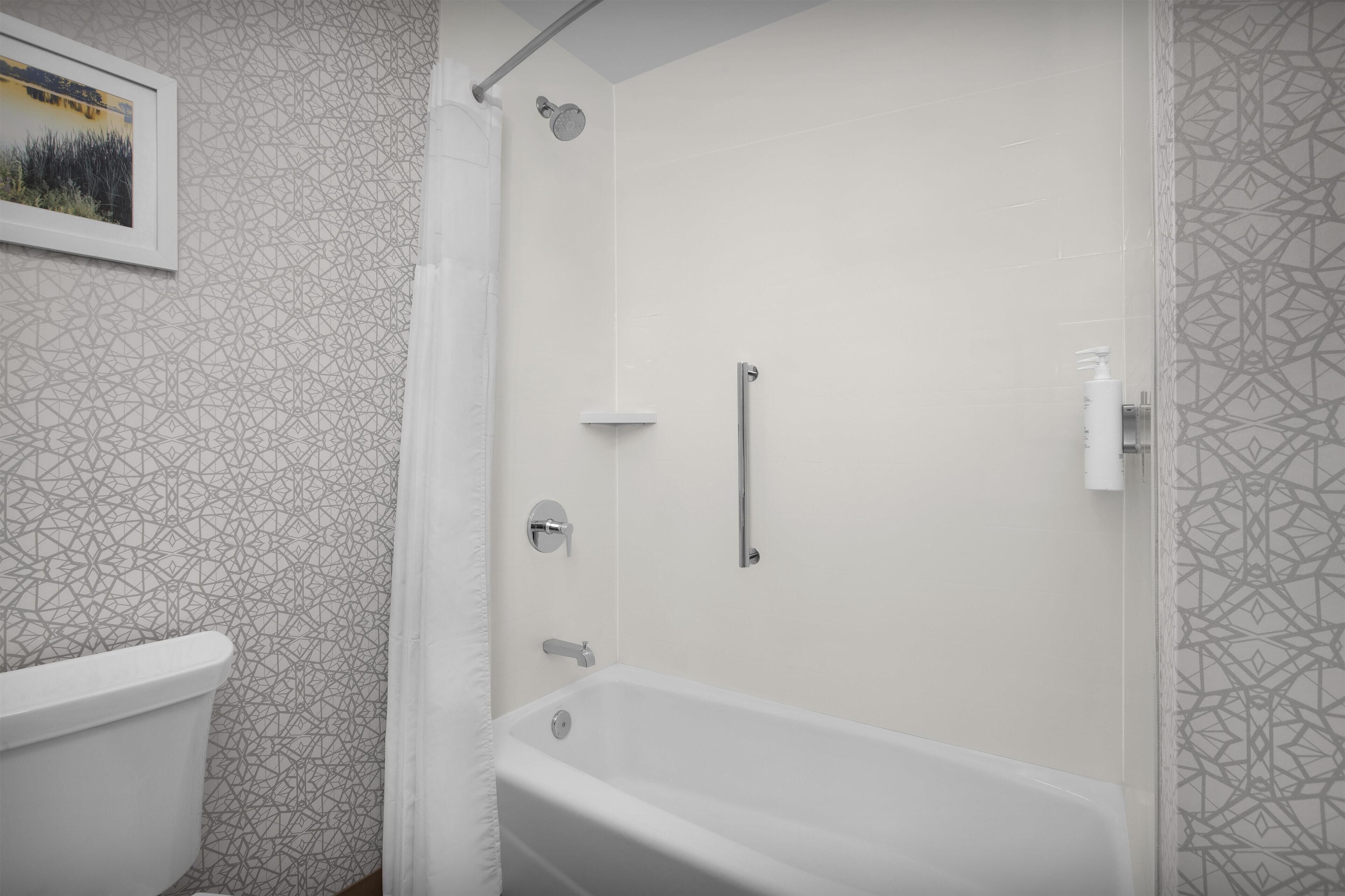 A bathroom with a bathtub, a shower, and a toilet.